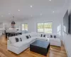 Living room featuring ornamental molding and light wood-type flooring