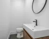 Bathroom featuring toilet, vanity, and tile patterned flooring