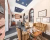 Living room featuring brick wall and a tray ceiling