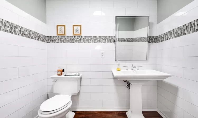 Bathroom with toilet and hardwood / wood-style floors