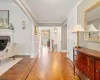 Foyer entrance with parquet flooring, a fireplace, and crown molding