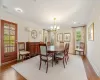 Dining space with light wood-type flooring, an inviting chandelier, and ornamental molding