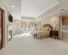 Carpeted bedroom with crown molding, a tray ceiling, and access to outside