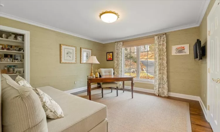 Bedroom featuring crown molding and hardwood / wood-style flooring