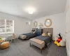 Carpeted bedroom with a baseboard radiator