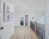 Corridor featuring ornamental molding and light hardwood / wood-style flooring