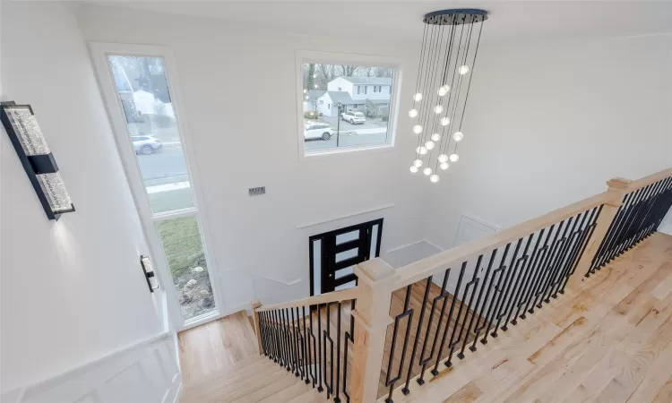 Stairway featuring ornamental molding and hardwood / wood-style floors