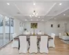 Dining space with coffered ceiling, a chandelier, light hardwood / wood-style floors, and beam ceiling