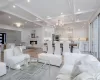 Living room featuring beamed ceiling, coffered ceiling, and a chandelier