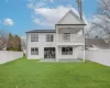 Rear view of house with a yard, a patio area, a balcony, and ceiling fan