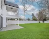 View of yard with a balcony, ceiling fan, and a patio area