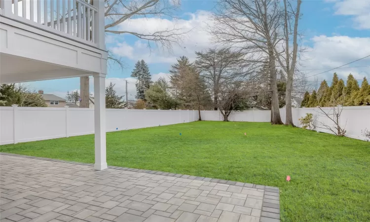 View of yard with a balcony