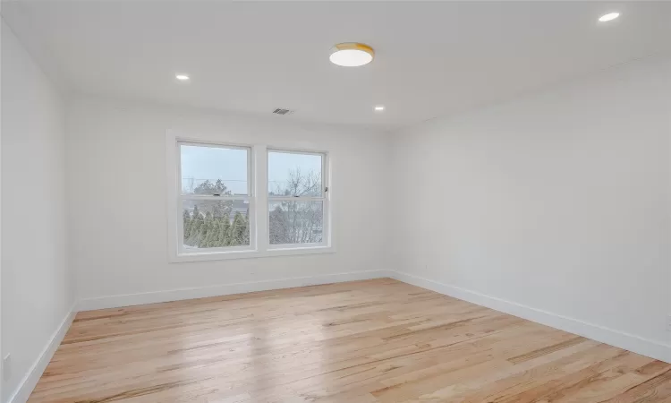 Unfurnished room featuring ornamental molding and light hardwood / wood-style floors