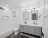 Full bathroom with vanity,  shower combination, and toilet