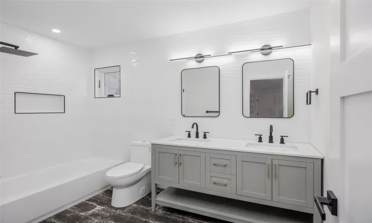 Full bathroom with vanity,  shower combination, and toilet