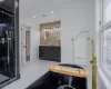 Bathroom with vanity, decorative backsplash, and a shower