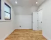 Additional living space featuring light wood-type flooring and vaulted ceiling