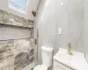 Bathroom with vanity, toilet, and a skylight