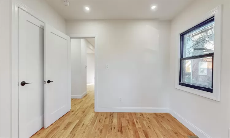 Unfurnished bedroom with light wood-type flooring