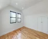 Bonus room featuring light hardwood / wood-style floors and lofted ceiling