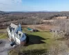 Birds eye late fall view of property with a mountain view