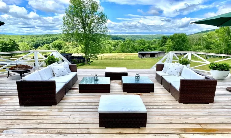 Deck and outdoor living space with a fire pit, and a storage unit