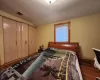 Bedroom with a closet, lofted ceiling, and dark hardwood / wood-style floors