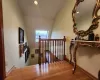 Stairway featuring vaulted ceiling