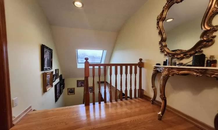 Stairway featuring vaulted ceiling