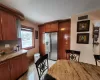 Kitchen with tasteful backsplash, stainless steel fridge, and light stone counters