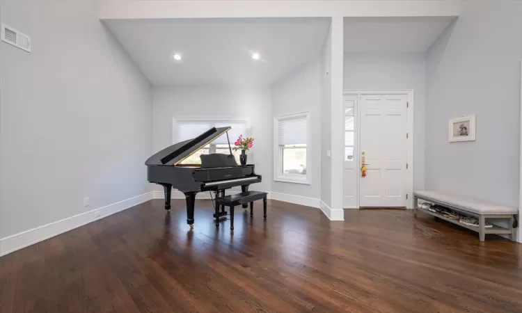 Living Room featuring dark hardwood / wood-style flooring and high vaulted ceiling