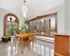 Dining room with a baseboard heating unit and a notable chandelier