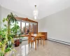 Dining area with baseboard heating and an inviting chandelier