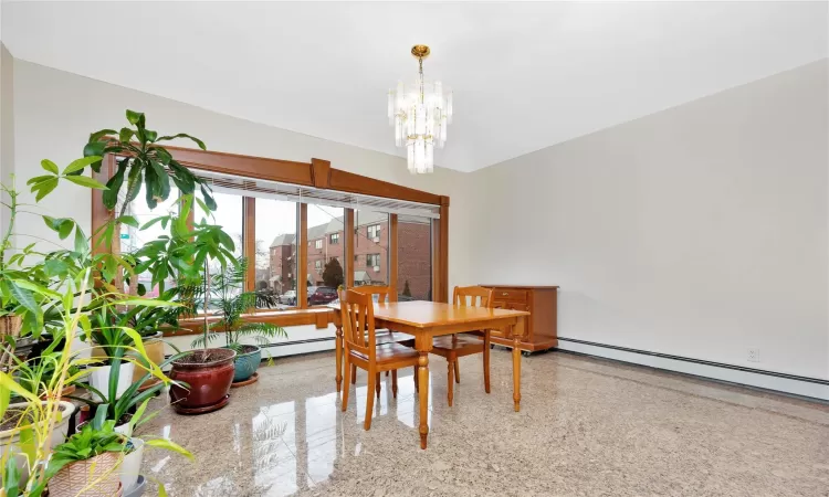 Dining area with baseboard heating and an inviting chandelier