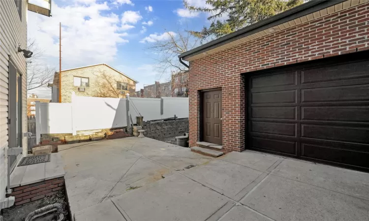 View of patio featuring a garage