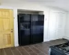 Kitchen featuring black refrigerator with ice dispenser and gas range oven