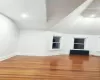 Living Room room with lofted ceiling, radiator, and hardwood / wood-style floors