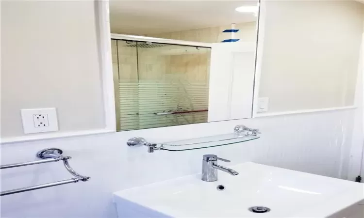 Bathroom with a tile shower and sink