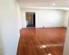 Bedroom room featuring dark wood-type flooring and a baseboard heating unit