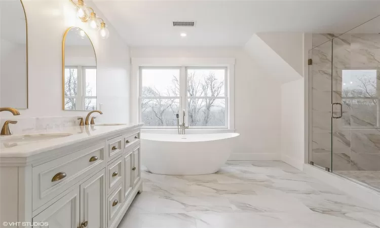 primary bathroom, soaking tub, and custom shower