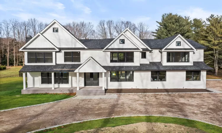 View of front of property with a yard and a porch