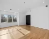 Spare room featuring light hardwood / wood-style flooring and vaulted ceiling