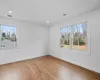 Bedroom with lofted ceiling and light hardwood / wood-style flooring (Virtually Staged)