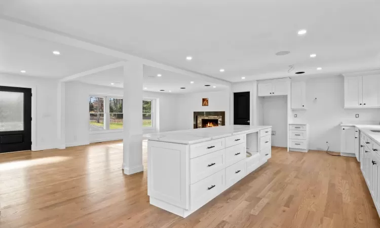 Unfurnished living room with light hardwood / wood-style floors and a fireplace