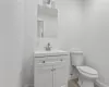 Kitchen featuring light stone counters, stainless steel appliances, a kitchen island, and white cabinets (Virtually Staged)