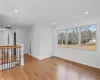 Kitchen featuring white cabinets, light wood-type flooring, and light stone countertops