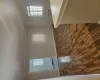 Unfurnished room featuring dark wood-type flooring, a wealth of natural light, a baseboard heating unit, and crown molding