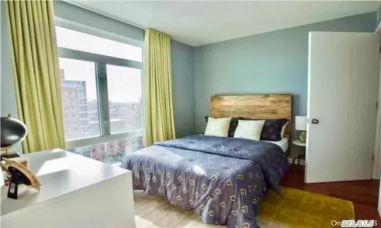 Bedroom with wood-type flooring