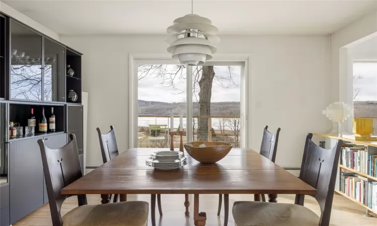 Dining room with light hardwood / wood-style floors and a baseboard radiator