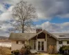 Back of house with french doors and solar panels